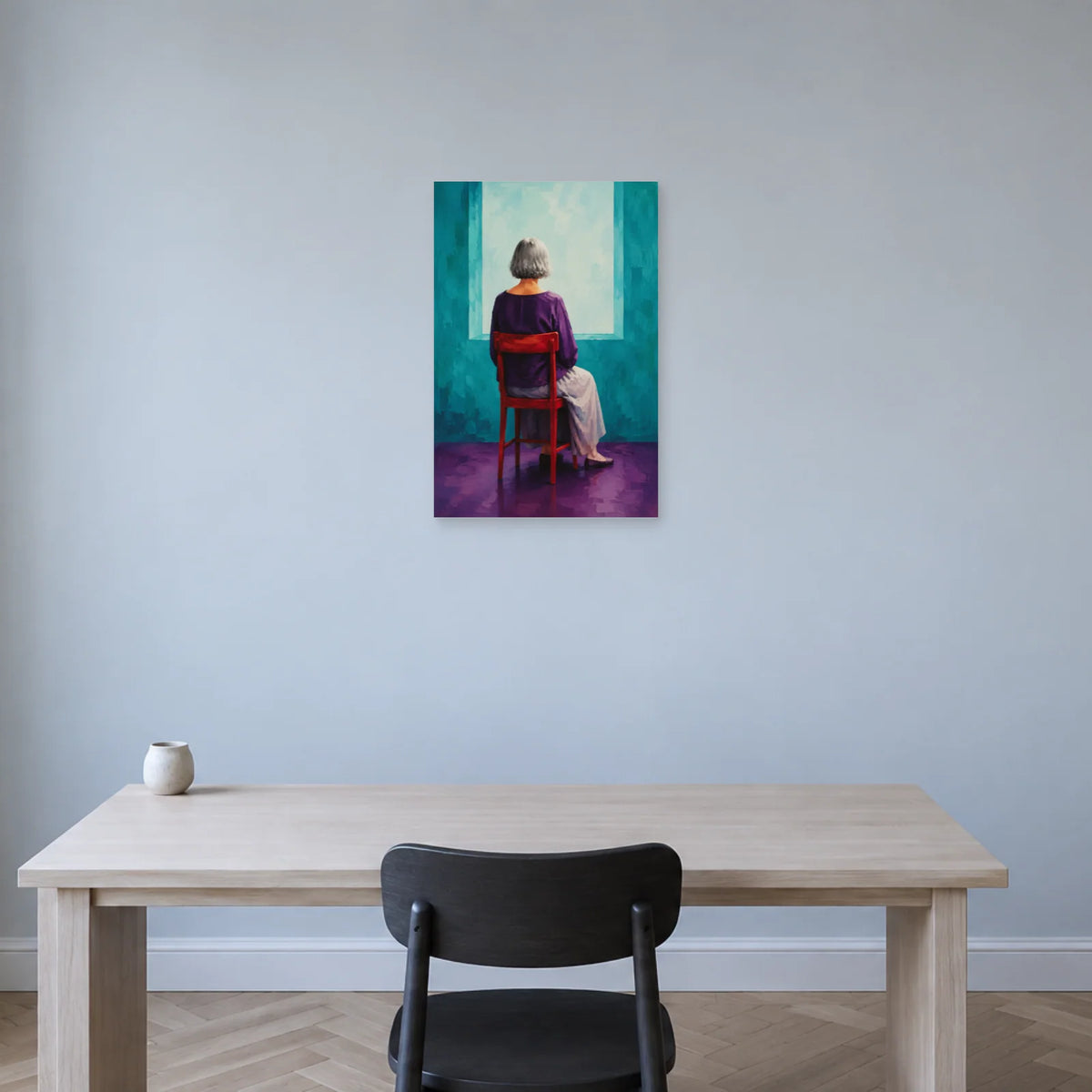 Grey-haired woman seen from behind on a red chair before a turquoise opening poster displayed above a pale wooden desk with a black chair against a light blue wall