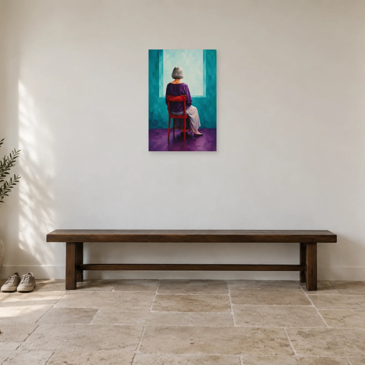 Grey-haired woman seen from behind on a red chair before a turquoise opening poster displayed above a low wooden bench in a bright entrance hall