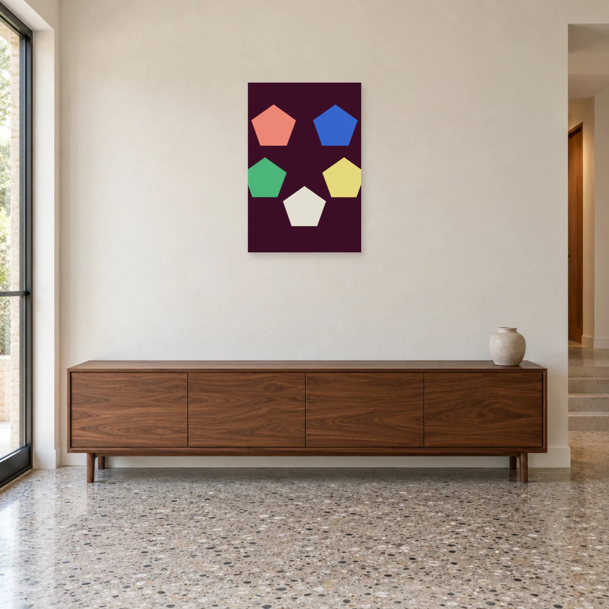 Pentagon poster above a low wooden sideboard beside a window